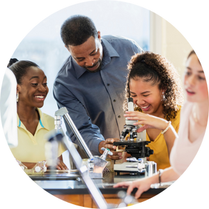 students at microscope with instructor advising